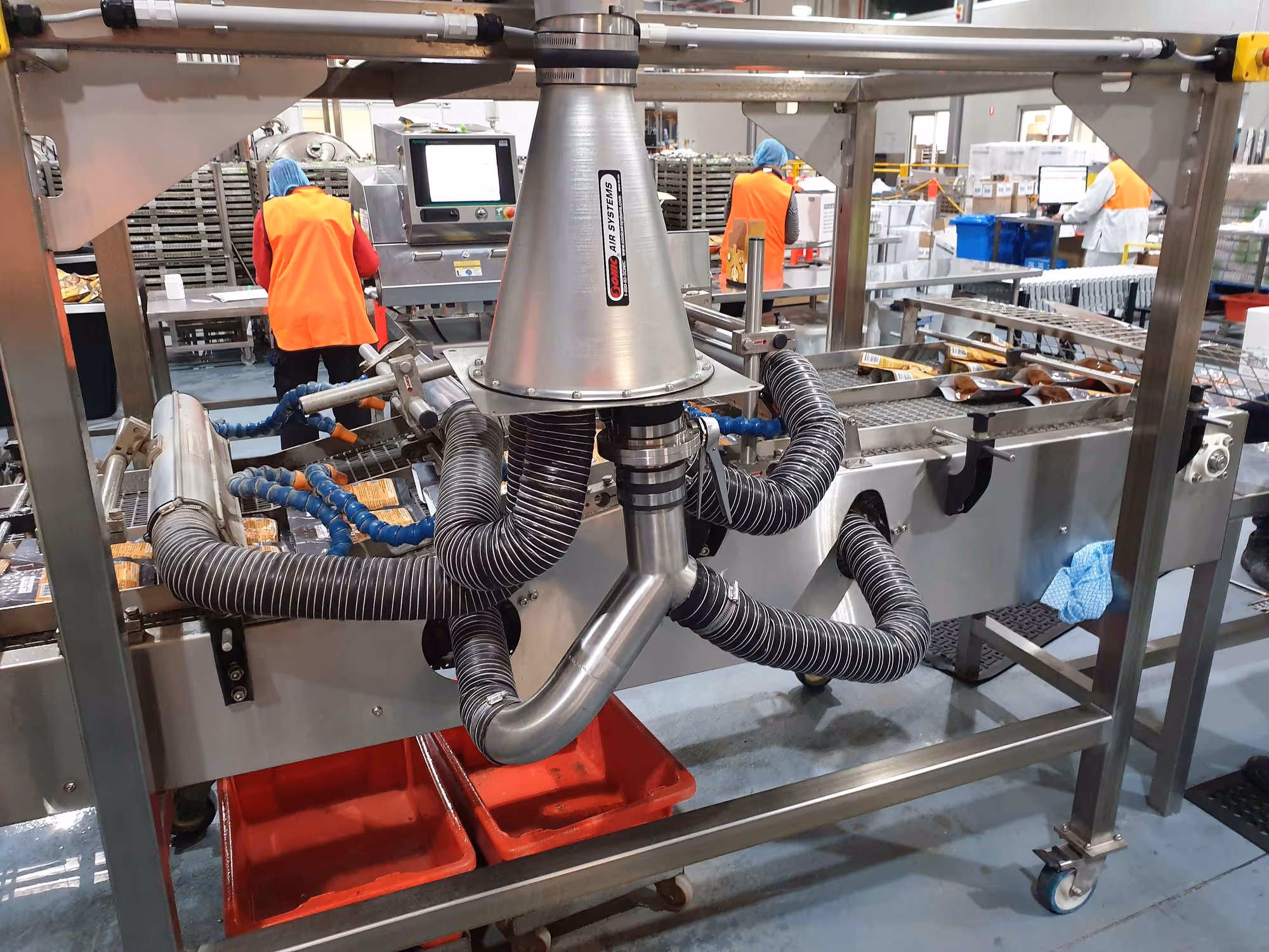 Sonic Air Systems air knife system installed on an industrial production line.